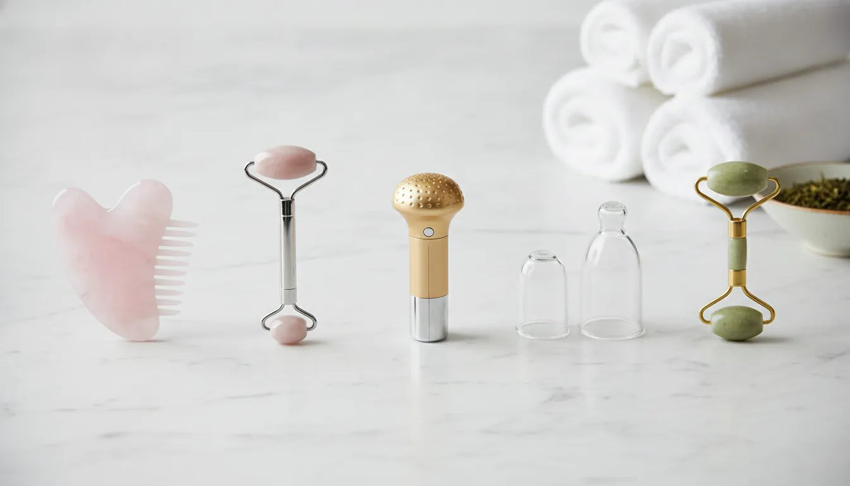Facial lymphatic drainage massage tools, including gua sha stones, rollers, cups, and a beauty wand.