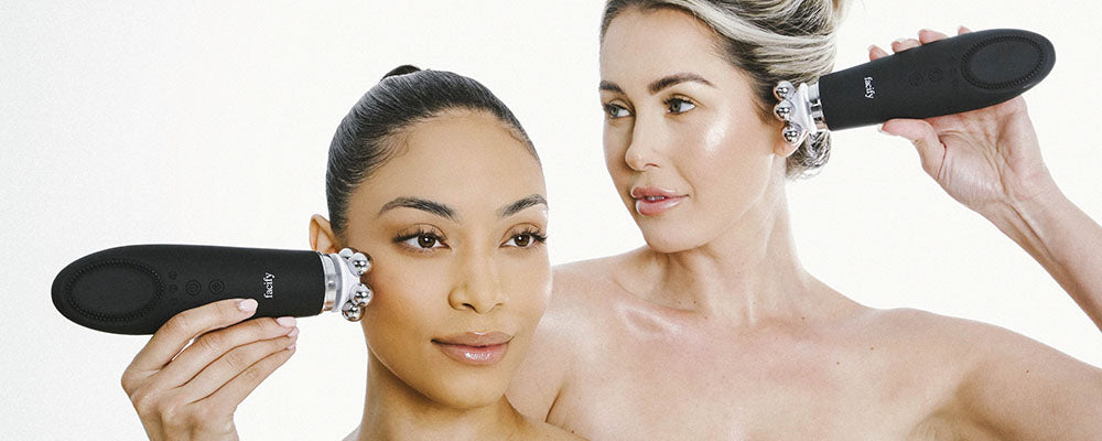 two women using the 5 iron head massager attachment on the facify beauty wand device on their face