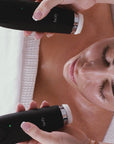 woman receiving a treatment using the large cleansing attachment of the facify wand